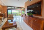 The living room seamlessly flows directly outdoors to the large, covered lanai.